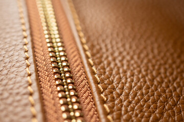 close up of zipper on brown leather bag
