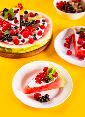 Colorful summer watermelon piece of cake with whipped cream and berries. Refreshment summer dessert food.