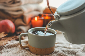 Teapot and cup with sea buckthorn tea, autumn mood