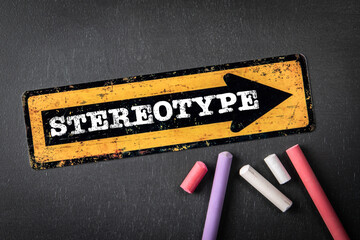Stereotype. Yellow directional arrow with text on a dark chalkboard background