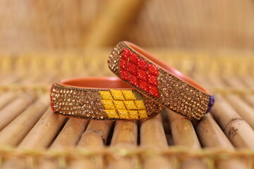 Rajasthani Style pair of Colourfull bangles or Kada on the bamboo table piles on each other 