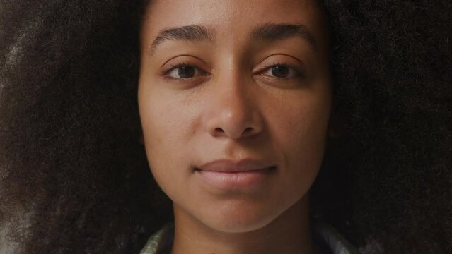 Black Woman Portrait. Cheerful African American female smiling looking at camera. Slow motion.