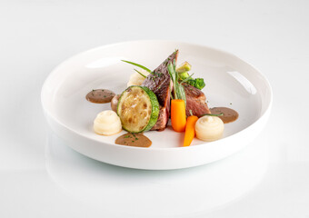 grilled beef steaks with white dish on white background