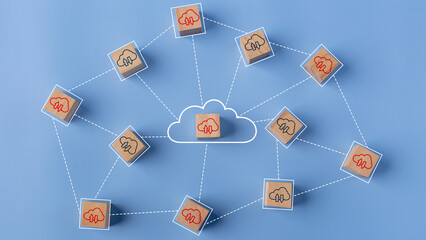 Cloud computing concept. Cloud icons on connected wooden cubes. The idea of sharing or transferring...
