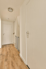 an empty room with white walls and wood flooring the door is open to let in light into the room