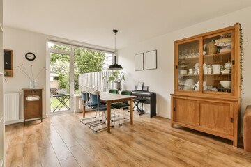 a living room with wood flooring and an open glass door leading to the patio area in the back yard