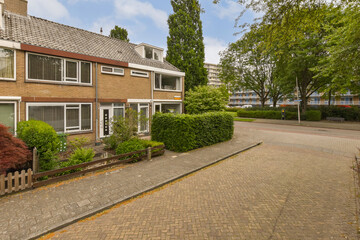 a street with houses and trees in the background, taken from an angle on a very sunny day - stock photo