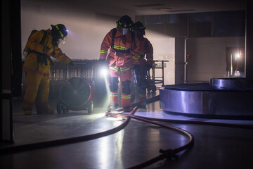 Firefighters are working in the airport at night. With the fire situation from terrorism