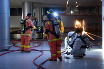 Firefighters are working in the airport at night. With the fire situation from terrorism
