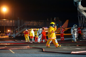 Firefighters are working in the airport at night. from the accident situation