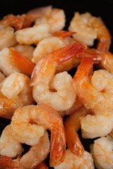 Fresh shrimps fried in oil pan, close up