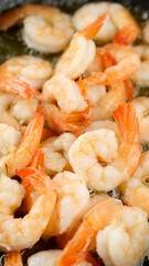 Fresh shrimps fried in oil pan, close up