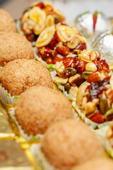 Close-up of different types of Indian sweets. Khoa Ladoo, Dryfruits Ladoo. Front view.