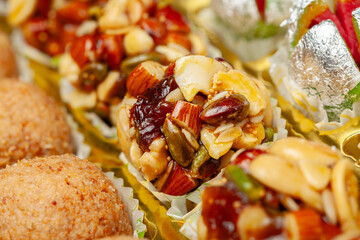Close-up of different types of Indian sweets. Khoa Ladoo, Dryfruits Ladoo. Front view.