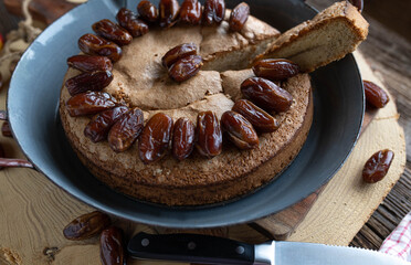 Hazelnut cake with dates on old fashioned background. Natural sweetness, clean baking
