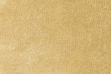 Terry cloth, yellow towel texture background. Soft fluffy textile bath or beach towel material. Top view, close up.