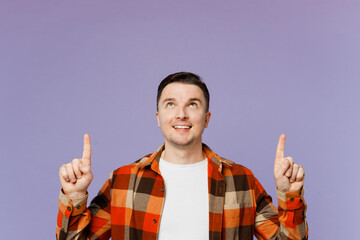 Young happy man he wear checkered shirt white t-shirt casual clothes point index finger overhead...