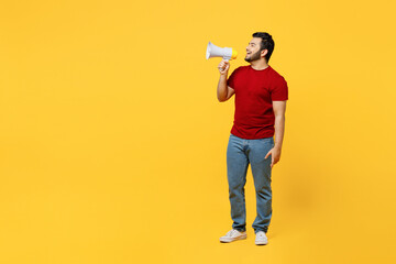 Full body young happy Indian man wears red t-shirt casual clothes hold in hand megaphone scream...