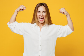 Young strong sporty fitness happy woman she wears white shirt casual clothes showing biceps muscles...