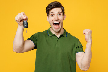 Young excited caucasian happy man wears green t-shirt casual clothes hold in hand car keys fob...