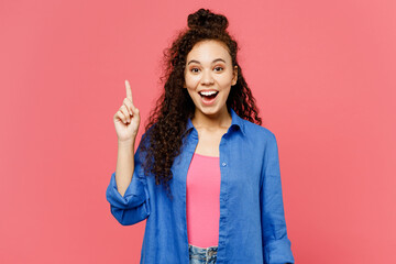 Young insighted smart proactive woman of African American ethnicity she wear blue shirt casual clothes holding index finger up with great new idea isolated on plain pink background. Lifestyle concept. - obrazy, fototapety, plakaty
