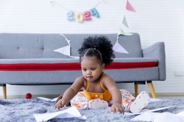 A cute curly hair girl  toddler's naughty play inside the living room.