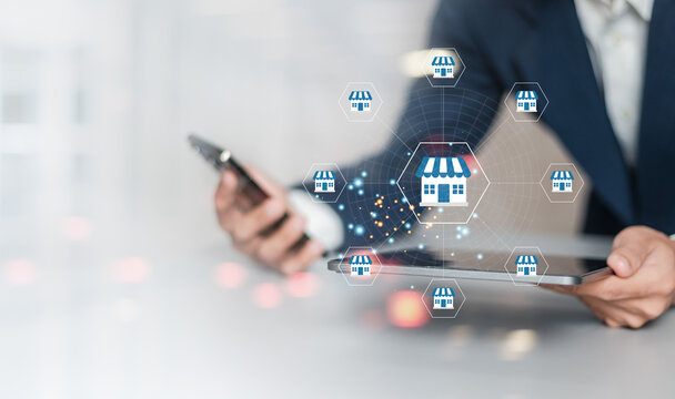 Franchise business concept. Businessman working on laptop with franchise marketing system icon in global networking. Branding business and modern technology.