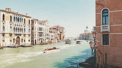Canal in Venice, Boats and gondolas with tourists float along canal, on sunny day