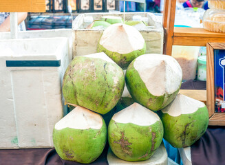 Fresh green coconuts selling on street market