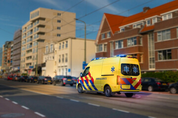 Yellow colored emergency ambulance car in the street, Den Haag (The hague), The Nederland.