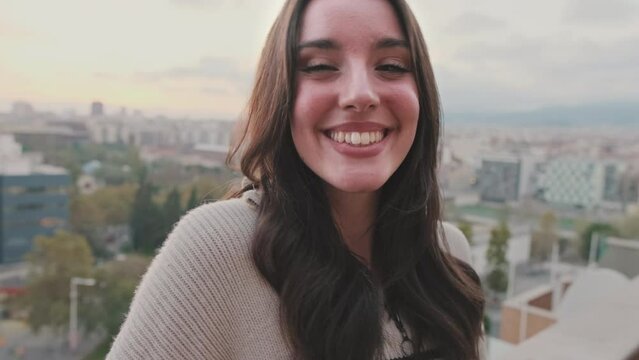 Close-up of beautiful young woman with charming smile posing at the camera