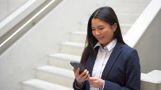 Business Woman taking a deep breath at staircase holding phone