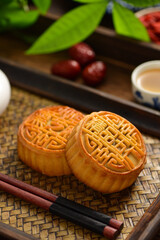 The Mid-Autumn Festival moon cake on the retro background. The Chinese meaning of the moon cake in the picture is: fine five kernels, black sesame, representing the taste of mooncakes