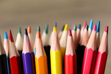 Colored, wooden pencils in a pile close-up.