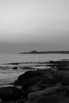Black and white view of Paphos Castle (Medieval Fort) seen from across the waterfront harbor