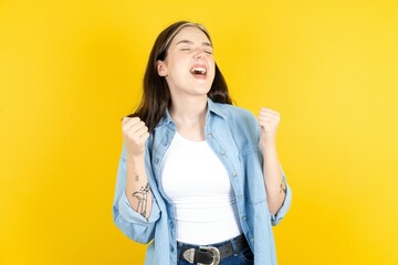 Beautiful woman wearing casual clothes celebrating surprised and amazed for success with arms...