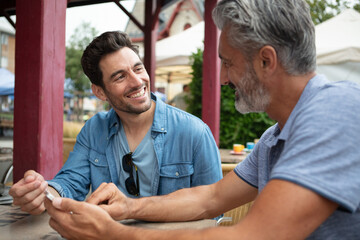 two men sitting at cafe