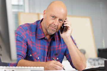 confident man in office on phone