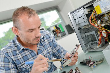 Computer expert repairing a printed circuit