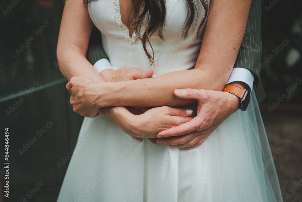 Wall mural bride and groom holding hands