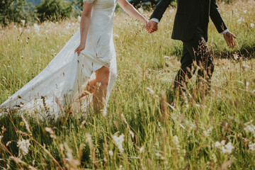 bride and groom walking in the park