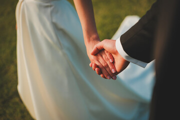 bride and groom holding hands