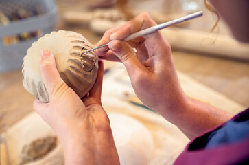 Close up of woman hands working in pottery studio workshop making bowl from clay. - obrazy, fototapety, plakaty