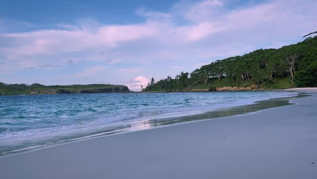 4k Video – Calm waves at the beautiful and remote Murrays Beach with pristine clear waters and pearly white sand at sunset in Booderee National Park, Jervis Bay Territory, NSW, Australia. 