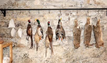 Castle pantry with hanging rabbits