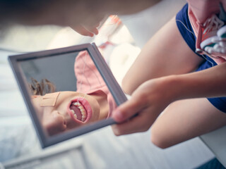 Unrecognizable boy pulling out tooth