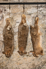 Castle pantry with hanging rabbits