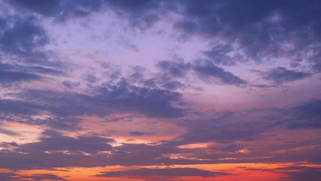 Time lapse of a sunrise sky. The vibrant hues paint a celestial canvas as the sun ascends, casting a warm glow, while clouds dance gracefully, creating a captivating spectacle of nature's artistry.
