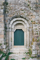 Fototapeta na wymiar Old stone archway with green door, Santuario de San Xiao de Moraime, Muxia, Galicia, Spain