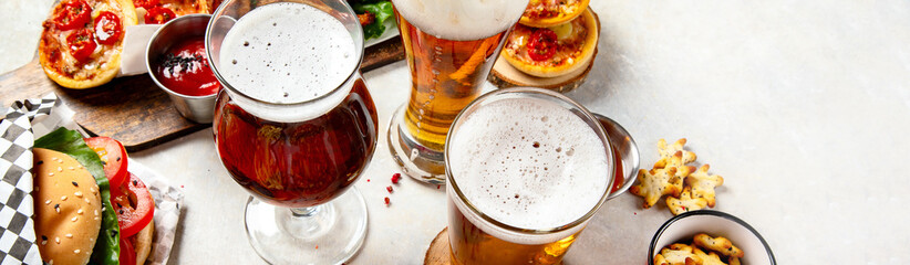 A selection of beer and snacks. Light beer, dark beer, live beer.